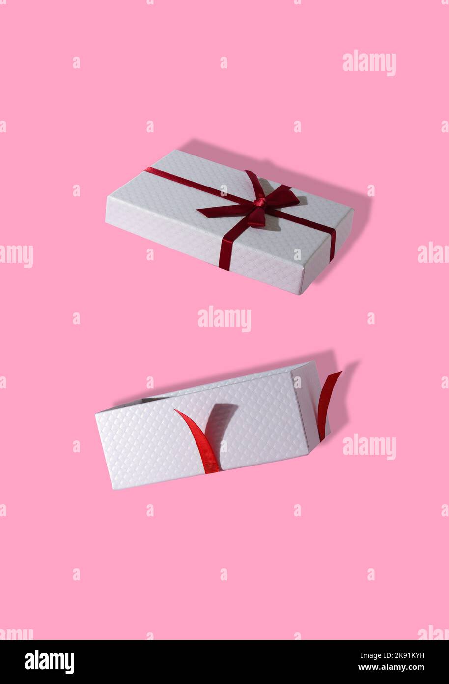 open gift package, creative holiday concept, pink background Stock Photo