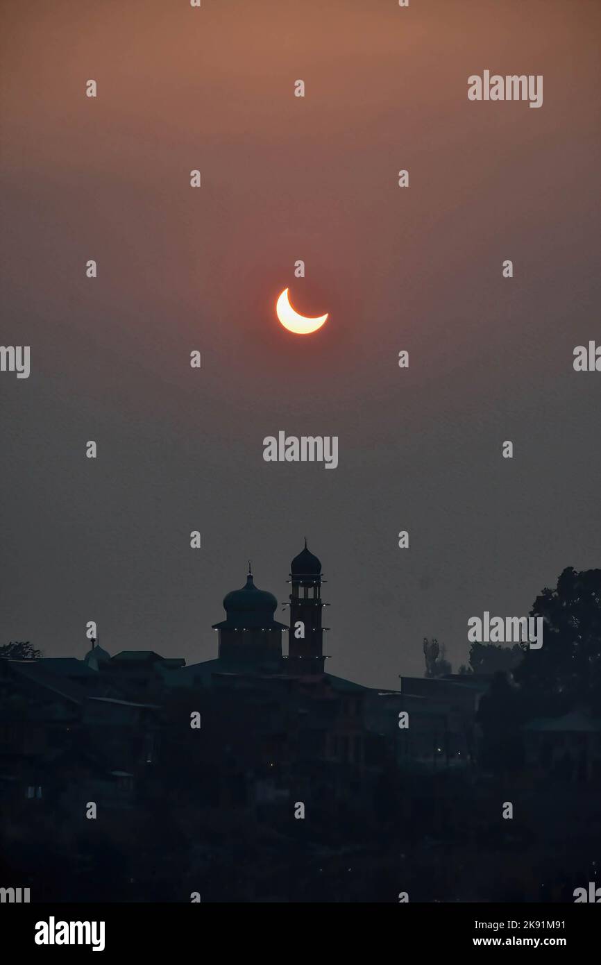 A partial solar eclipse is seen over the Mosque in Srinagar. The