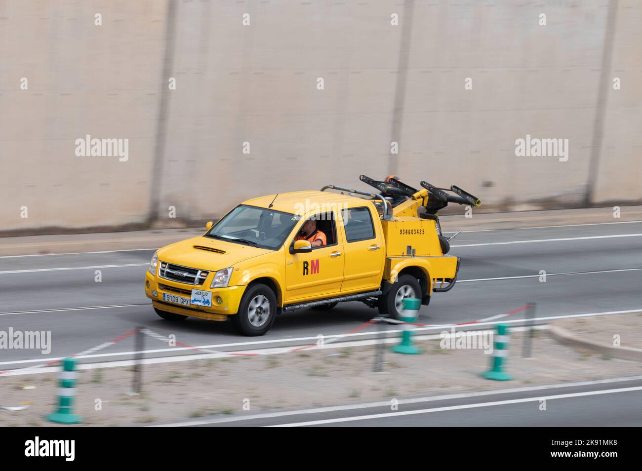 A Yellow Isuzu D-Max LS tow truck along Barcelona's Ronda Litoral Stock Photo