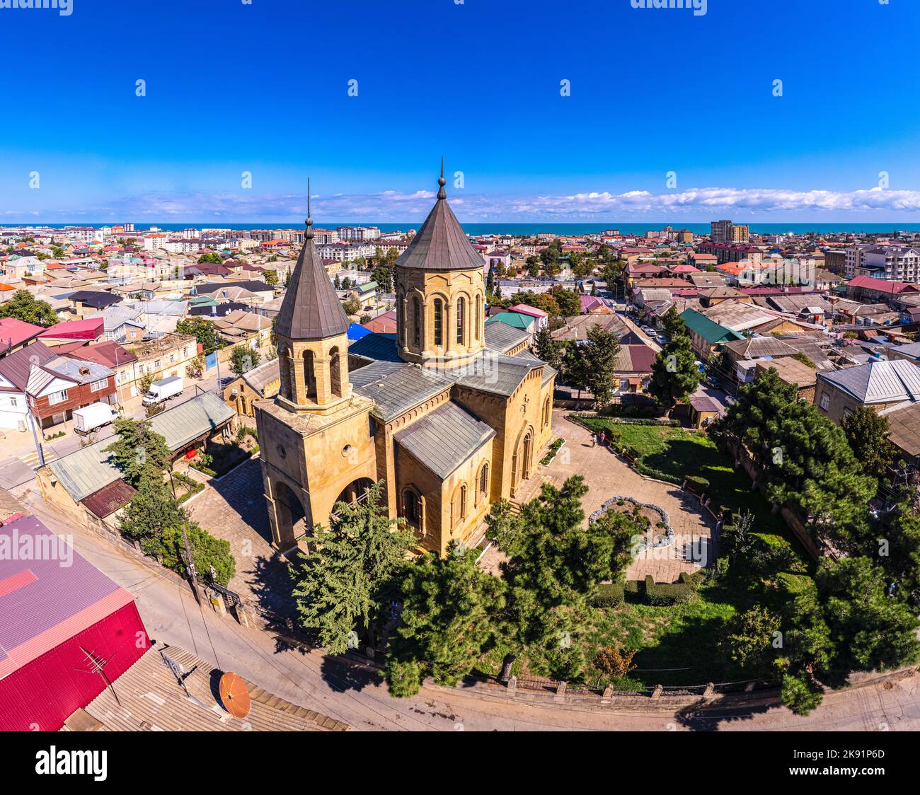 Aerial drone view to old town Derbent, caspian sea and Armenian Church of the Holy Saviour Surb Amenaprkich. Now Museum of Carpet and Decorative and A Stock Photo