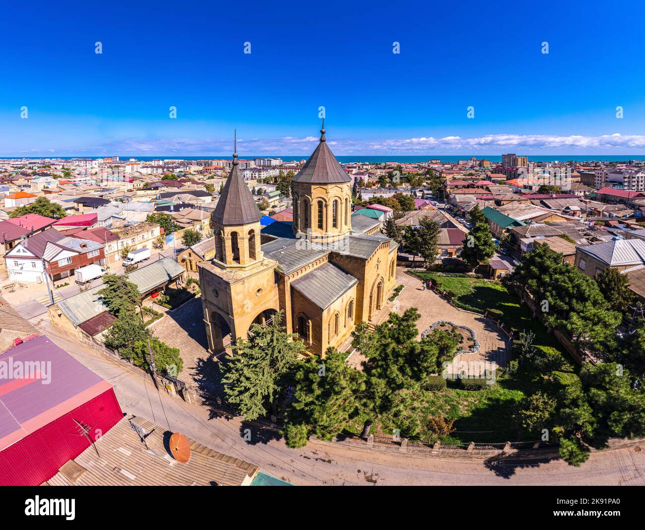 Aerial drone view to old town Derbent, caspian sea and Armenian Church of the Holy Saviour Surb Amenaprkich. Now Museum of Carpet and Decorative and A Stock Photo