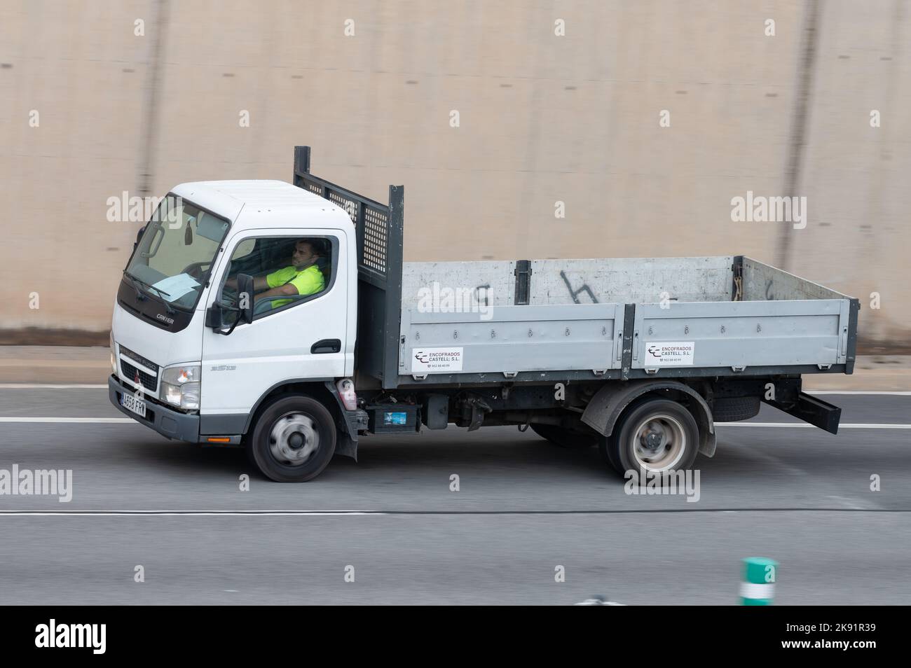 A white Mitsubishi Fuso Canter truck driving along the Ronda Litoral in Barcelona Stock Photo