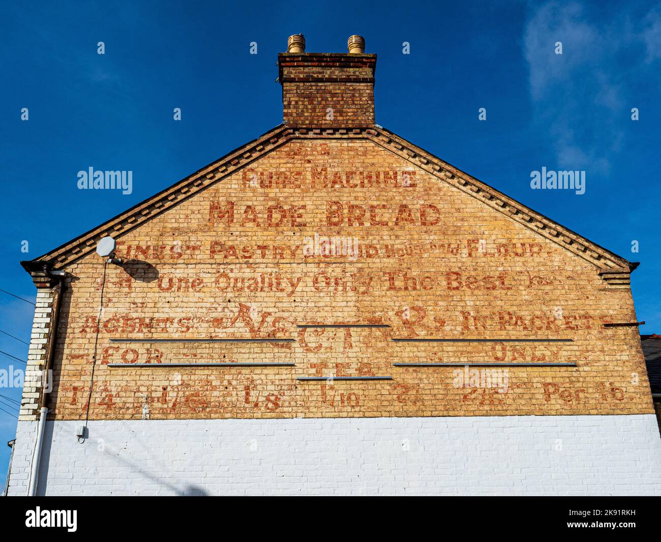 Ghost Signs. Ghostsigns. Vintage gable end signs in Cambridge UK. Bakery Ghost sign on a building in Cambridge UK for machine made bread & Nectar Tea. Stock Photo