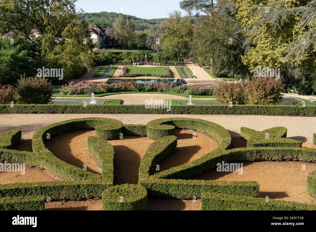 a designer garden with topiary hedges and flower borders, Chateau des Milandes, former home of Josephine Baker, Dordogne France Stock Photo