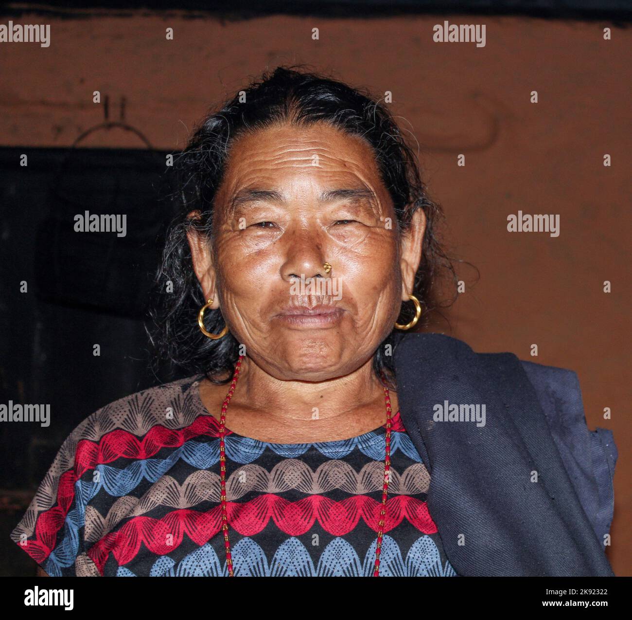 JOMSON, NEPAL - OCT 13, 2013: portrait of old nepalese woman. She wears a nose jewelry as symbol of wealth. Stock Photo