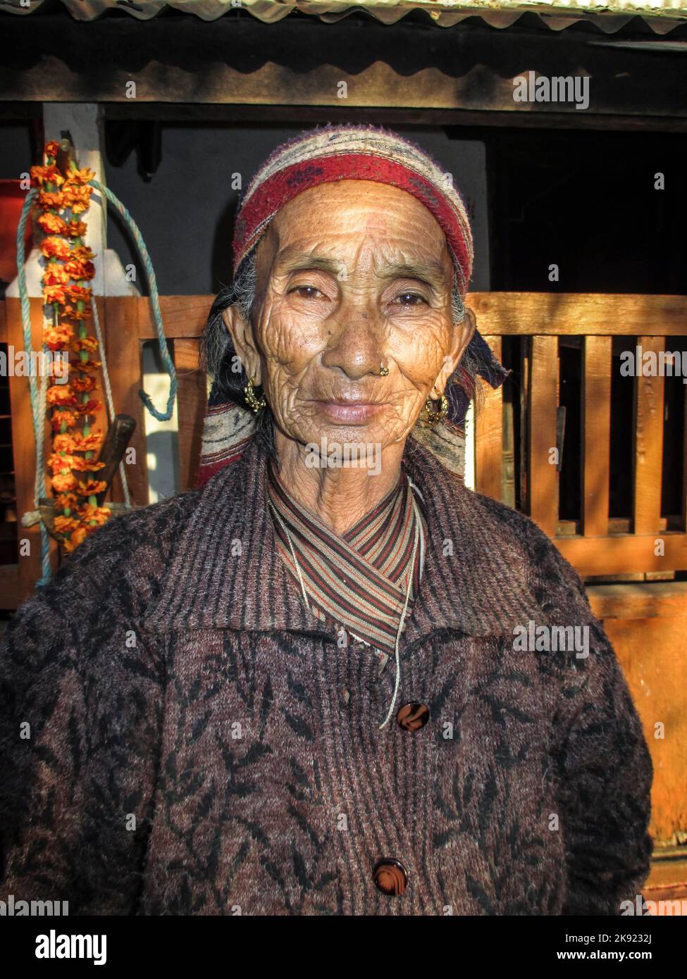 JOMSON, NEPAL - DEC 2, 2013: portrait of old nepalese woman. She wears a golden nose jewelry to show her wealth. Stock Photo