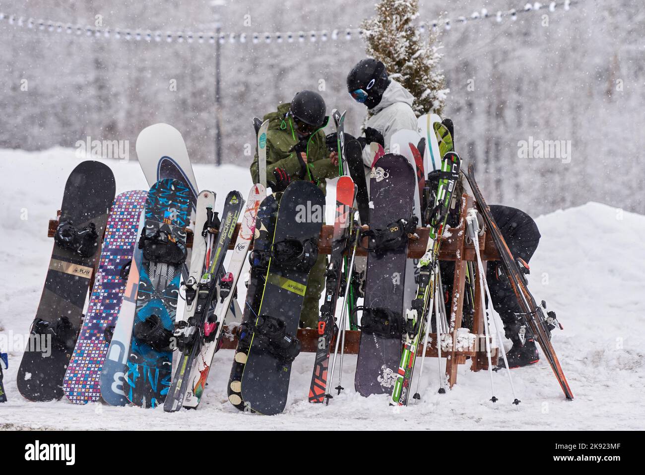 Snowboards and skis stand at a special rack in a ski resort Stock Photo