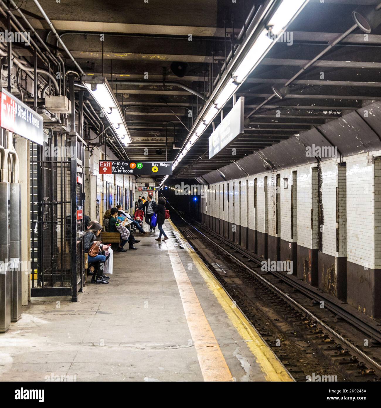 NEW YORK, USA - OCT 25, 2015: People wait at subway station 9th street ...