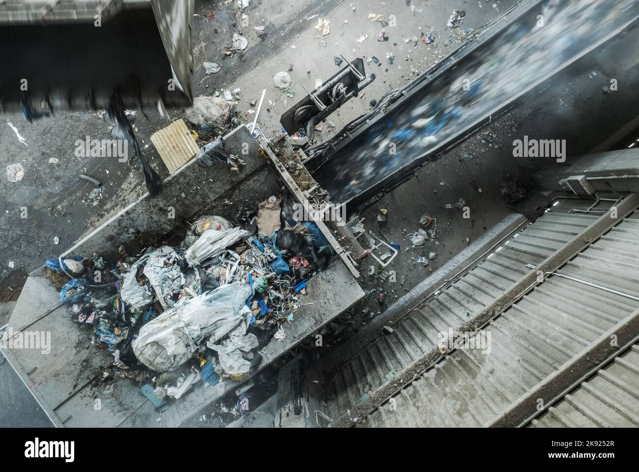 Waste Processing Machine Shredding Trash at the Garbage Treatment Plant. Aerial View. Pollution Control Theme. Stock Photo
