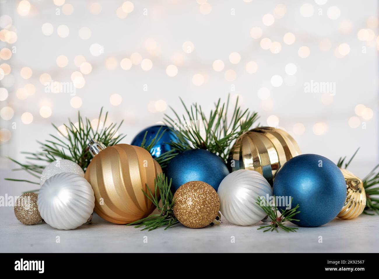 Christmas card with fir and decor on glitter background Stock Photo - Alamy