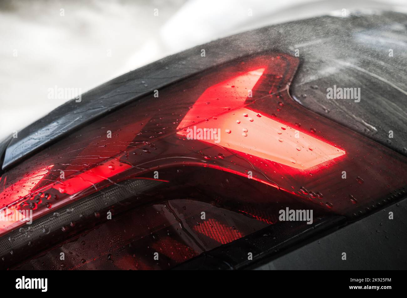 Closeup of Modern Luxury Car Rear Lights Covered with Drops of Water