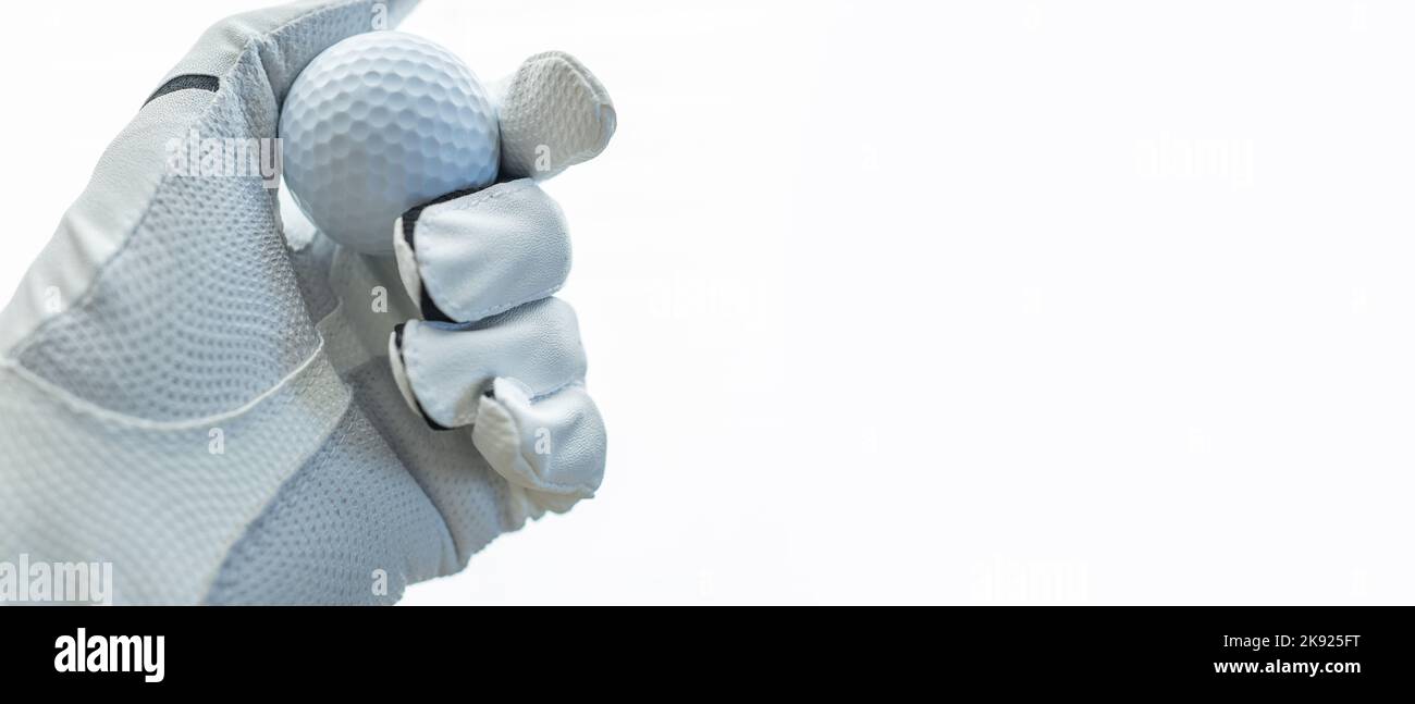 Closeup of Golfer’s Left Hand in White Leather Glove Holding Golf Ball. White Background with Copy Space. Stock Photo