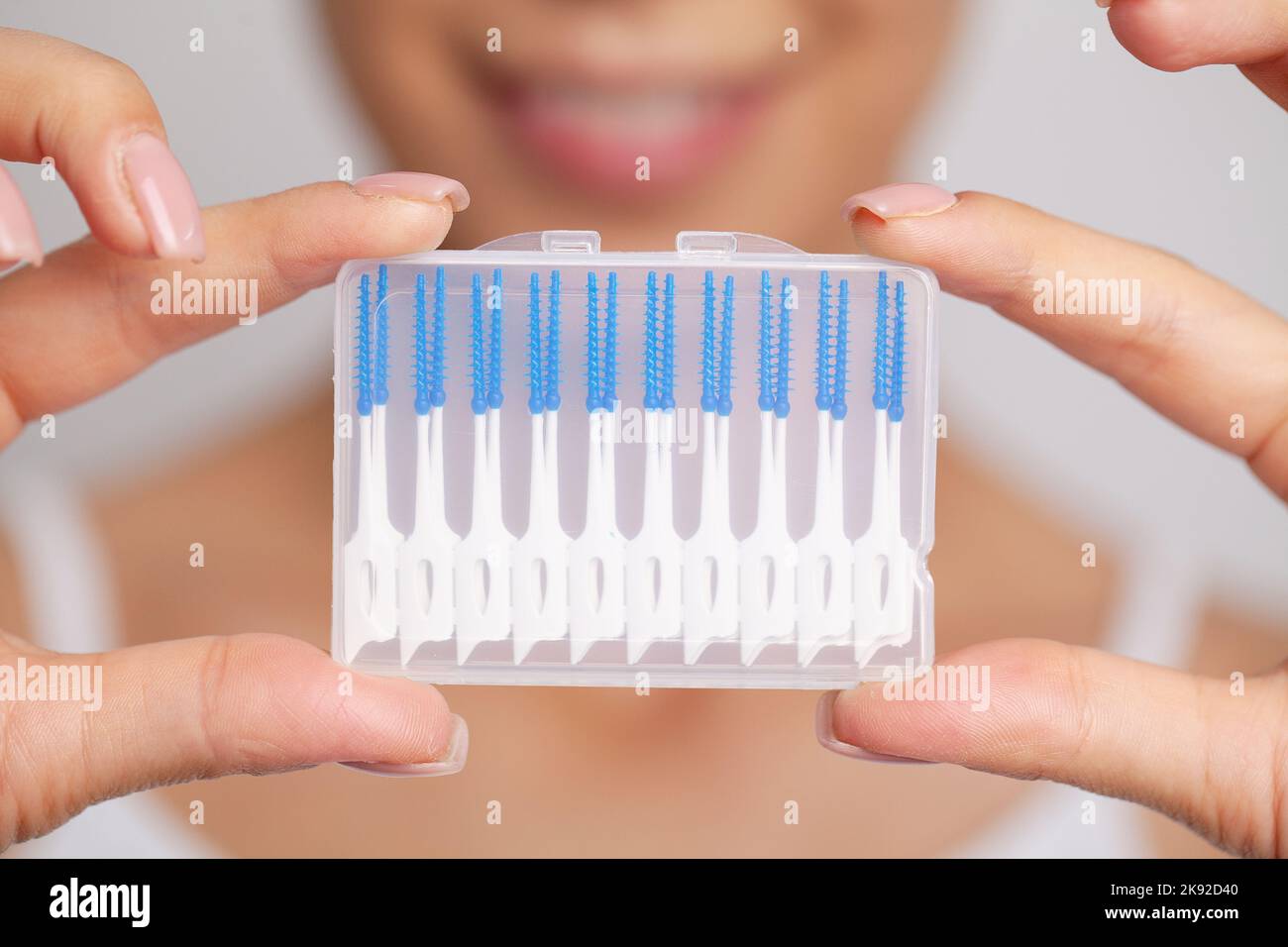 The woman uses brushes to clean the interdental spaces Stock Photo Alamy