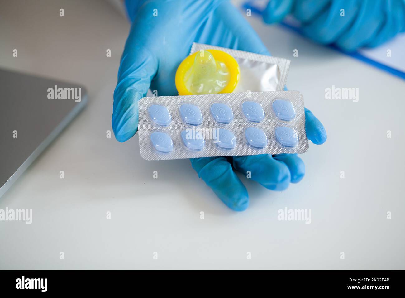 Close up doctor holding pill and condom for men health Stock Photo Alamy