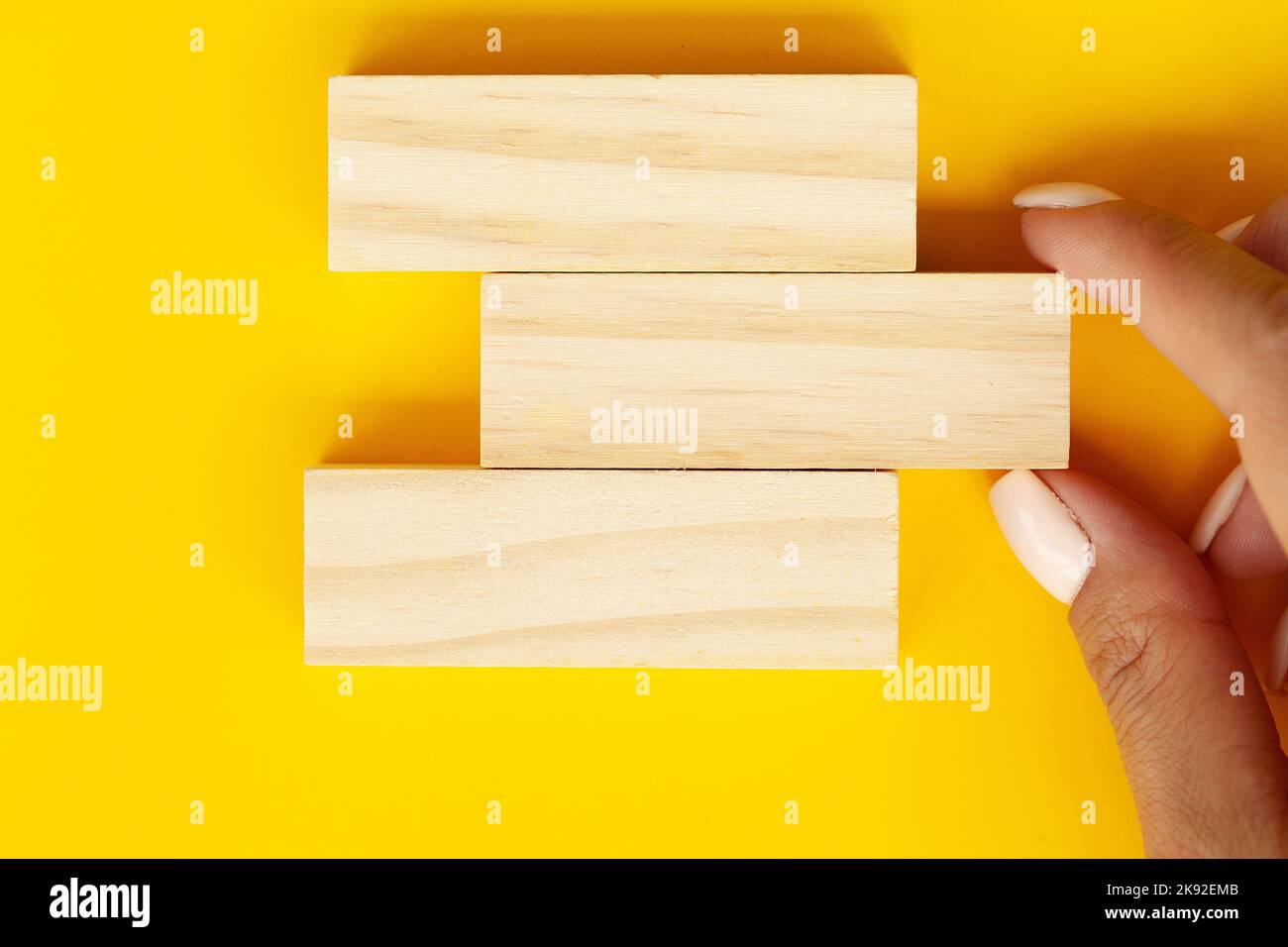 Hand Stack Wall Blocks Woman hand stacked wooden blocks with space for text Stock Photo - Alamy