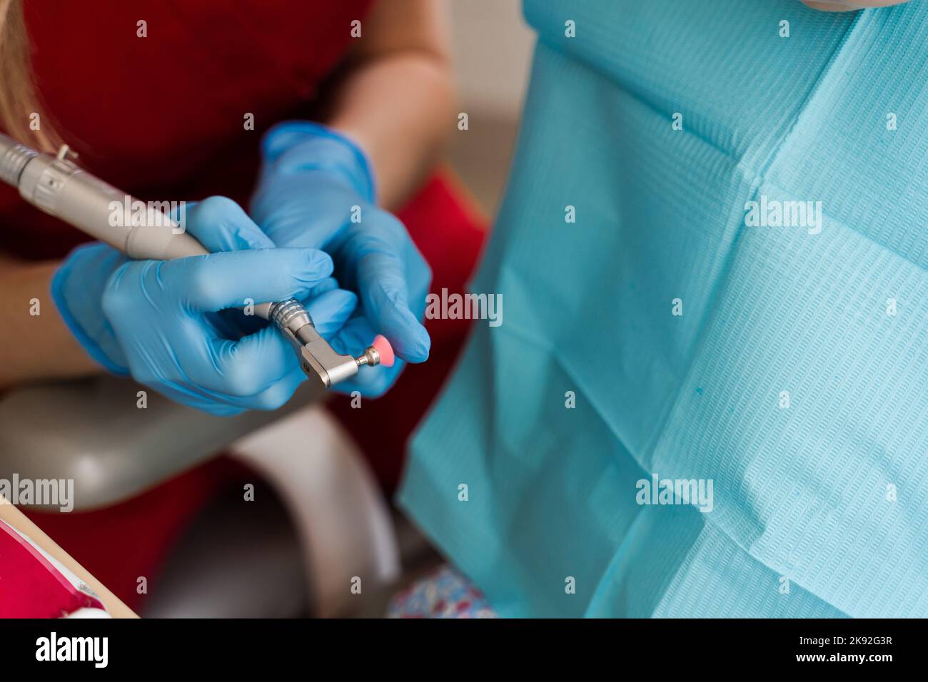 Pediatric dentist showing professional teeth cleaning tools closeup in