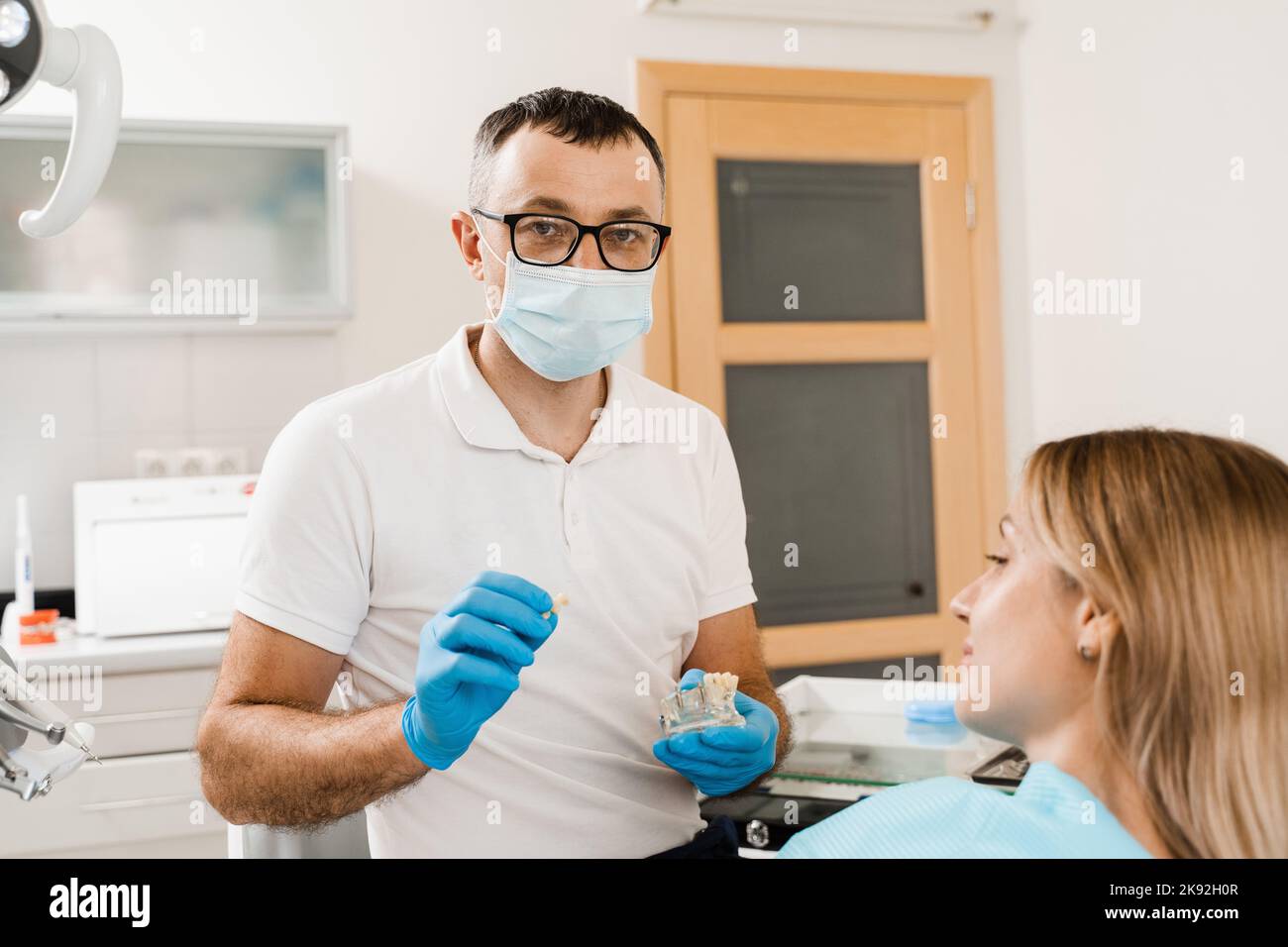 Dental prosthetics and implants. Doctor dentist shows artificial