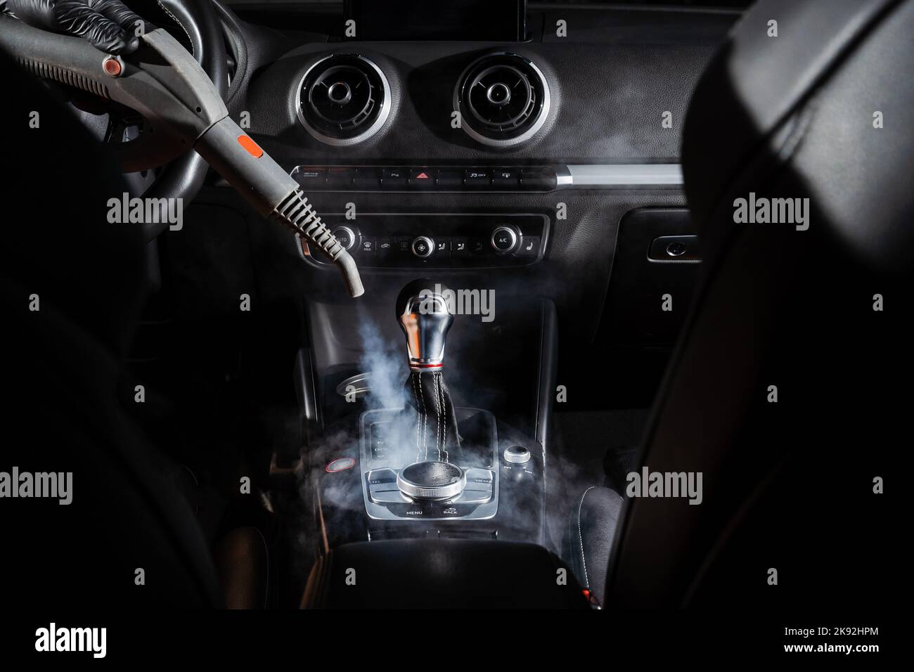 Steam cleaning of gearbox and dashboard in car. Vaping steam. Cleaning