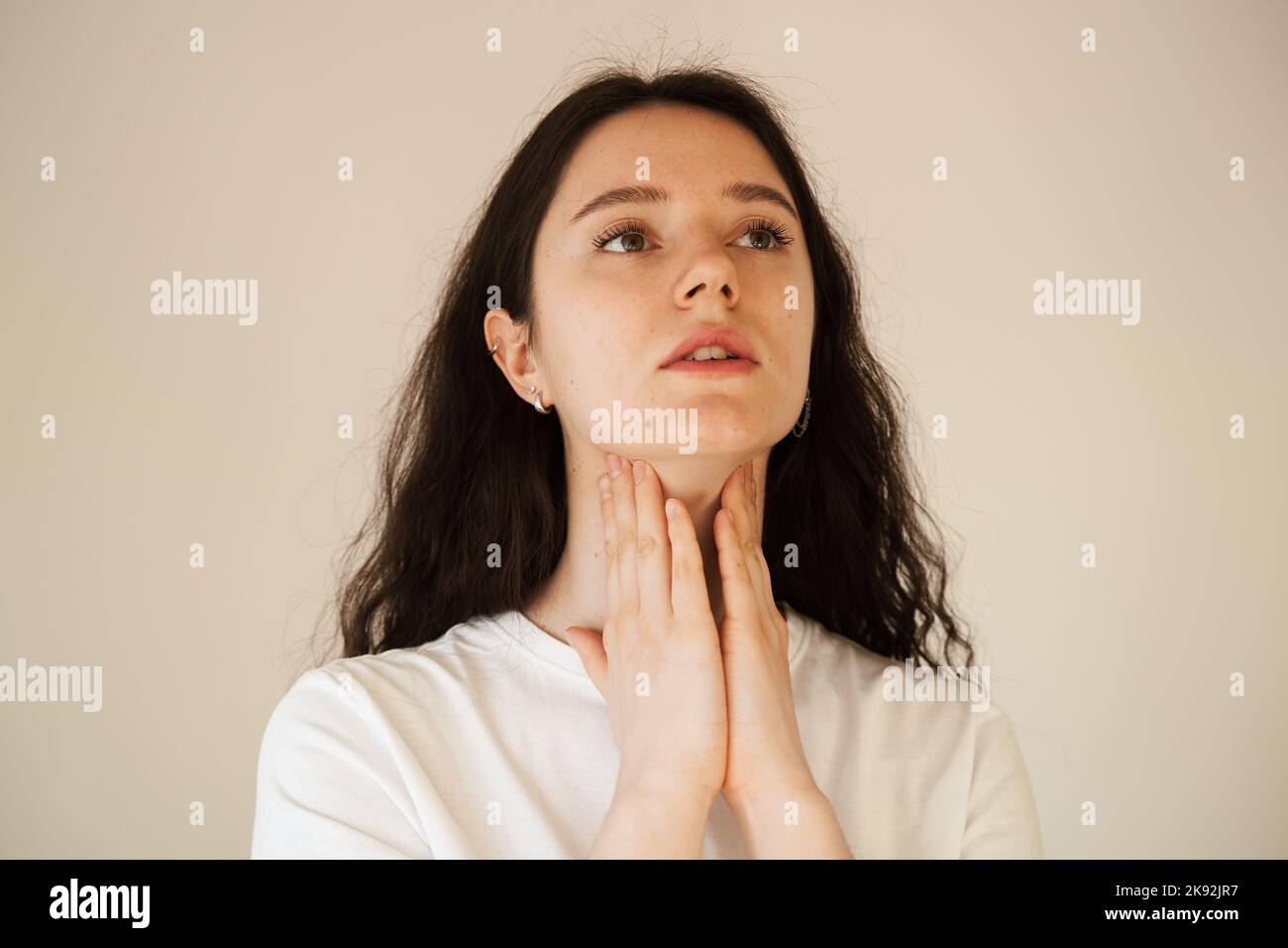 Laryngitis first symptoms throat ache. Sick attractive girl touches