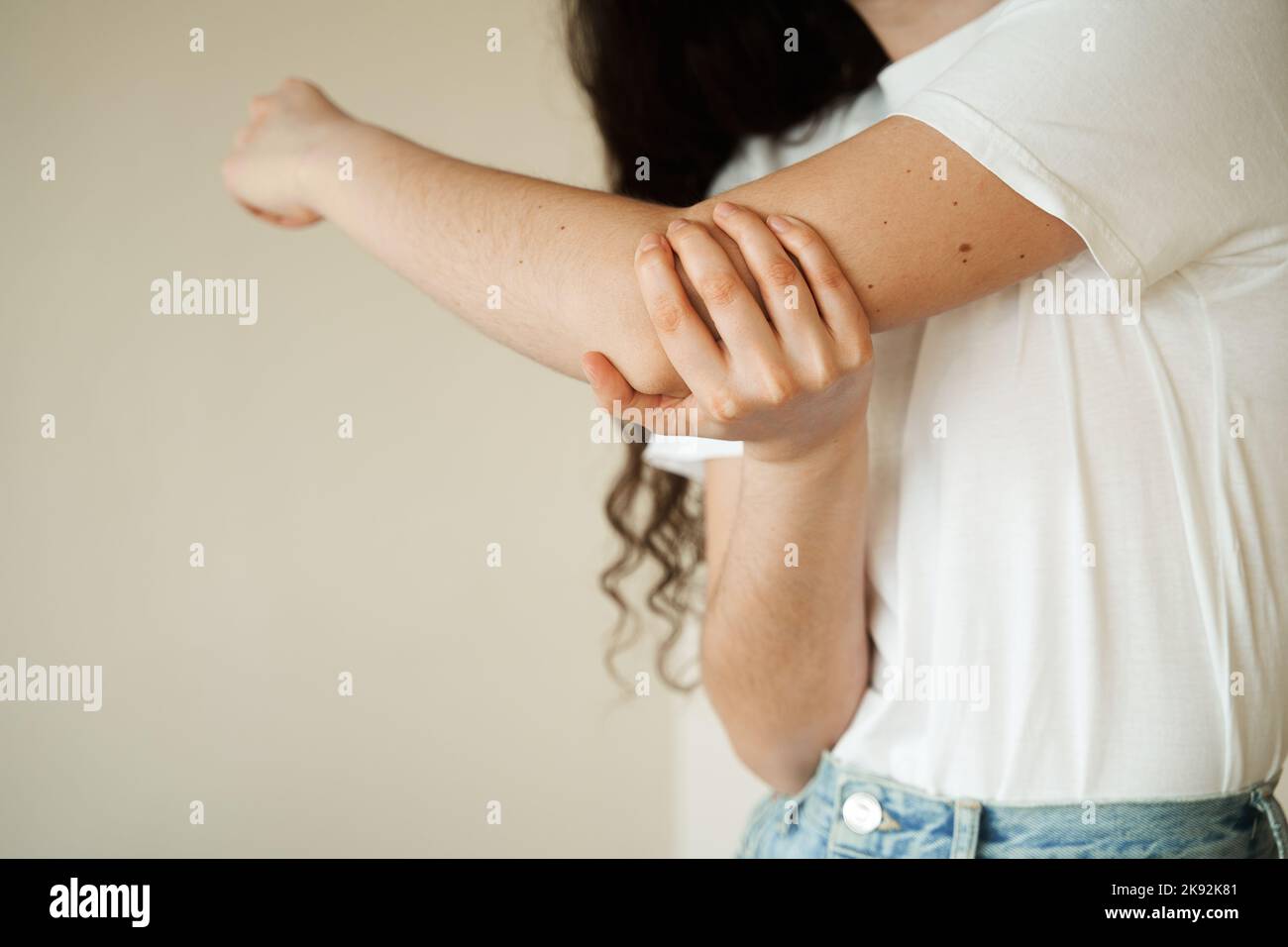 Elbow injury. Beautiful girl with pain and bruise in her arm due to an