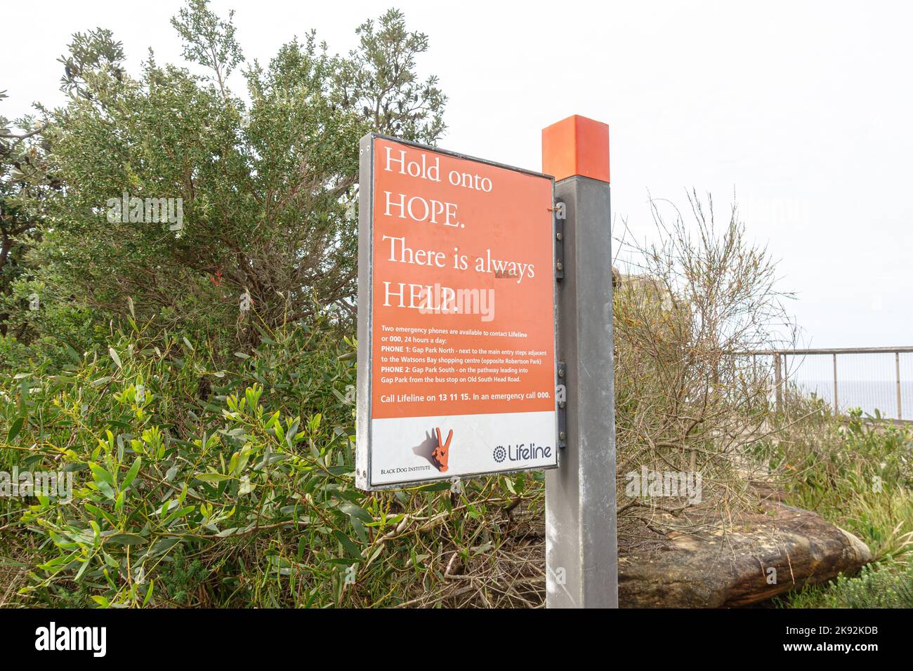 A sign for the Lifeline suicide prevention crisis hotline at The Gap in Watson's Bay, Sydney, Australia Stock Photo