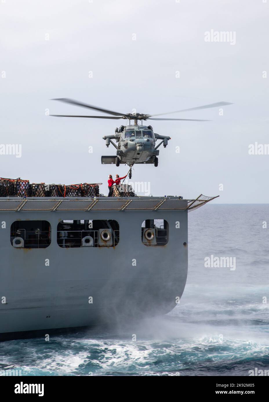 221023-N-ET093-1051 ADRIATIC SEA (Oct 23, 2022) Sailors assigned to the Lewis and Clark-class dry cargo and ammunition ship USNS William Mclean (T-AKE 12), attach cargo to an MH-60S Nighthawk helicopter, attached to Helicopter Sea Combat Squadron (HSC) 5, during a replenishment-at-sea with the Nimitz-class aircraft carrier USS George H.W. Bush (CVN 77), Oct. 23, 2022. Carrier Air Wing (CVW) 7 is the offensive air and strike component of Carrier Strike Group 10, George H.W. Bush Carrier Strike Group (CSG). The squadrons of CVW-7 are Strike Fighter Squadron (VFA) 86, VFA-103, VFA-136, VFA-143, C Stock Photo