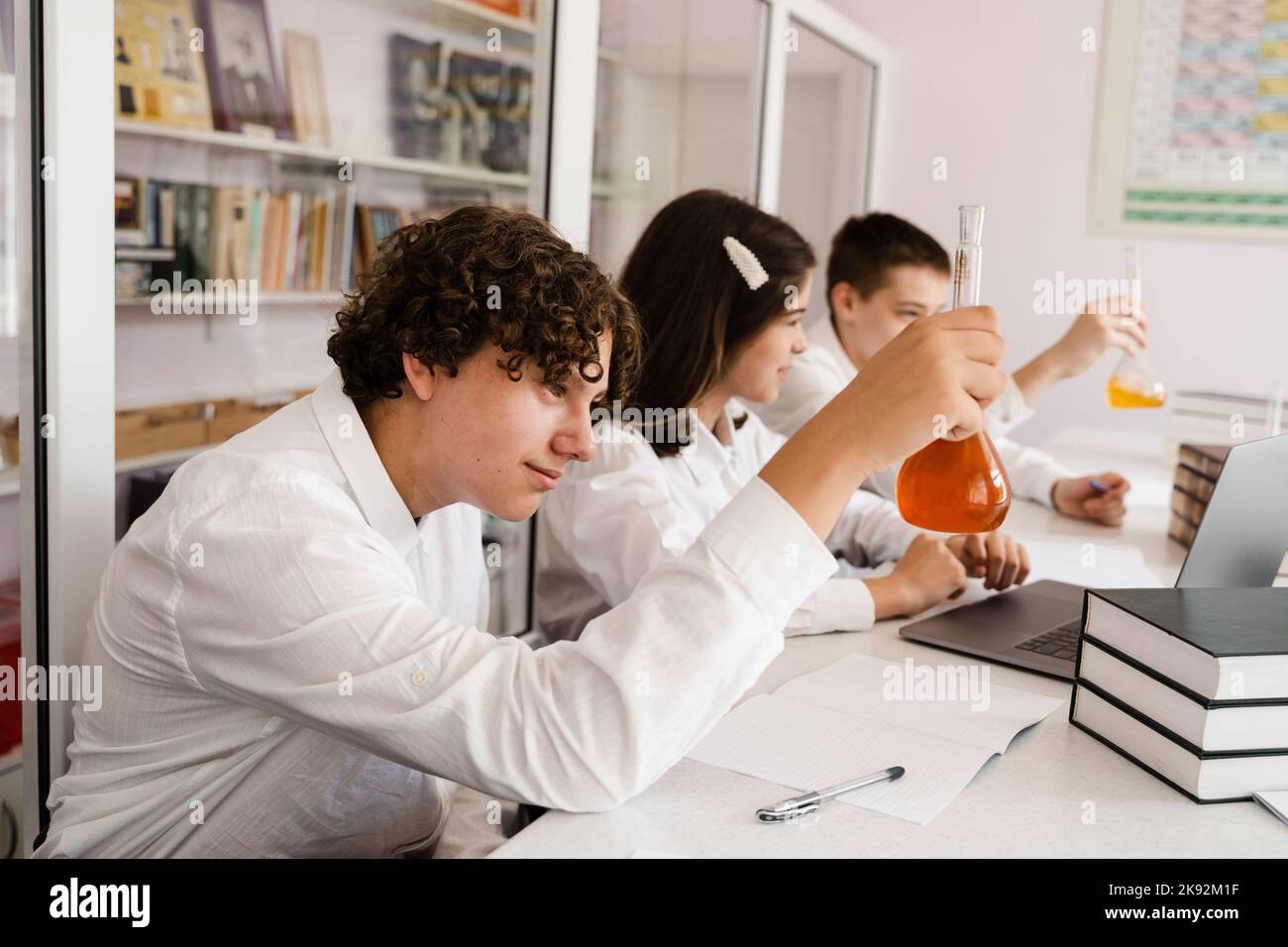 Pupilt Lab Pupil holding flask with liquid for experiments in laboratory ...