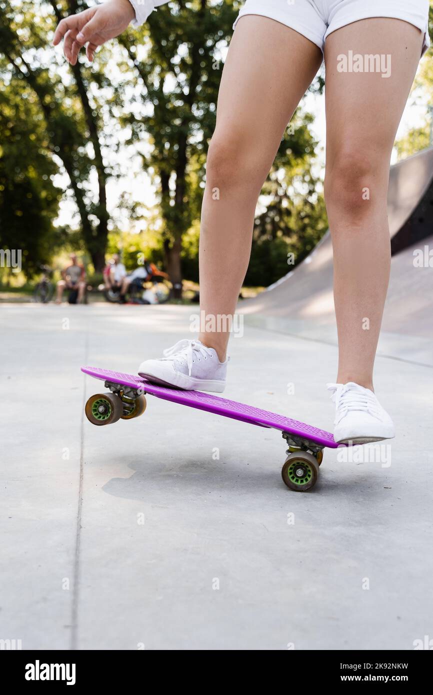Child girl riding on penny board close up. Sports equipment for kids ...