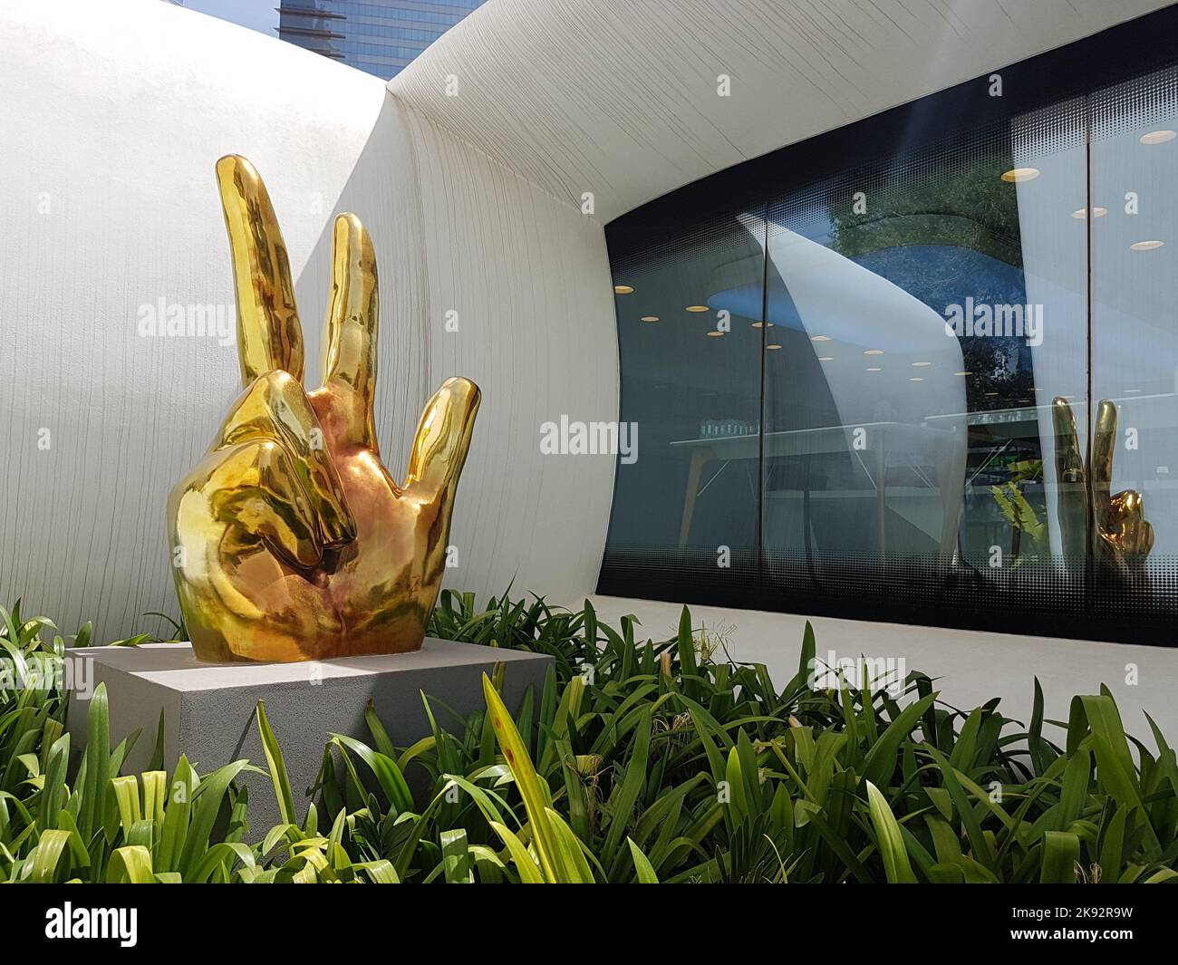 Gold three-finger salute statue outside Dubai Future Foundation. Hand gesture created by Sheikh Mohammed bin Rashid al Maktoum, UAE prime minister. Stock Photo