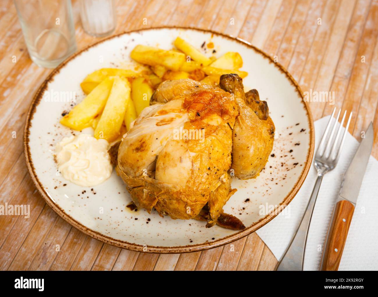 Chicken legs with potatoes and sauce Stock Photo - Alamy