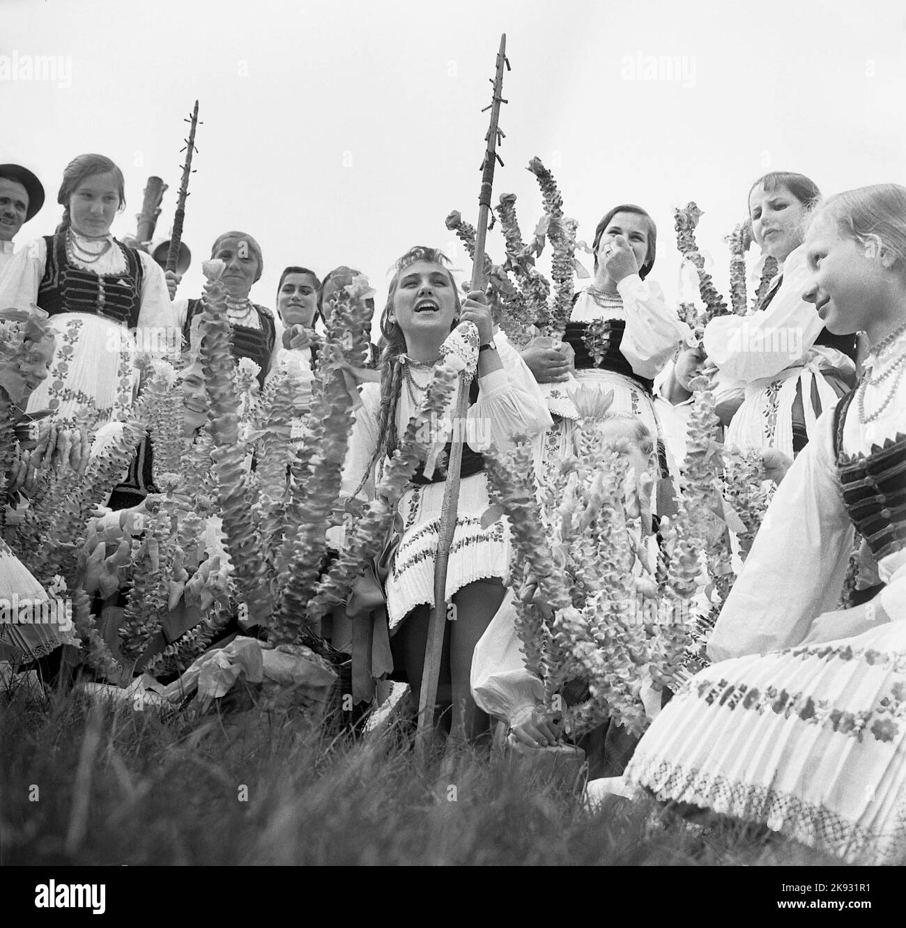 Covasna County, Romania, approx. 1974. Hungarian ethnics wearing their folk costumes celebrating 'Farsang' with the traditional doughnuts. Stock Photo