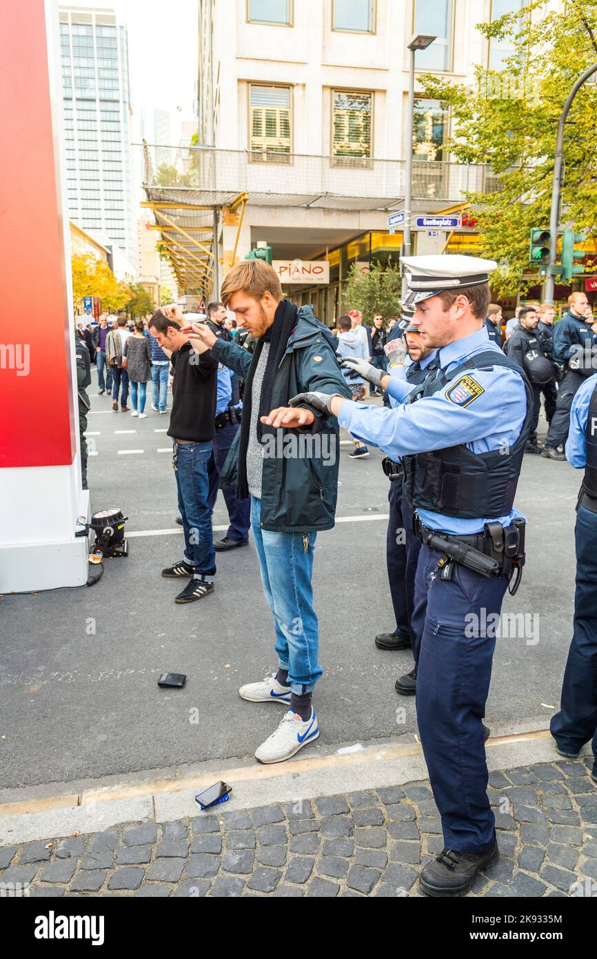 FRANKFURT, GERMANY - OCT 3, 2015: demonstrant is checked by police at 25th anniversary of German Unity in Frankfurt, Germany. Stock Photo