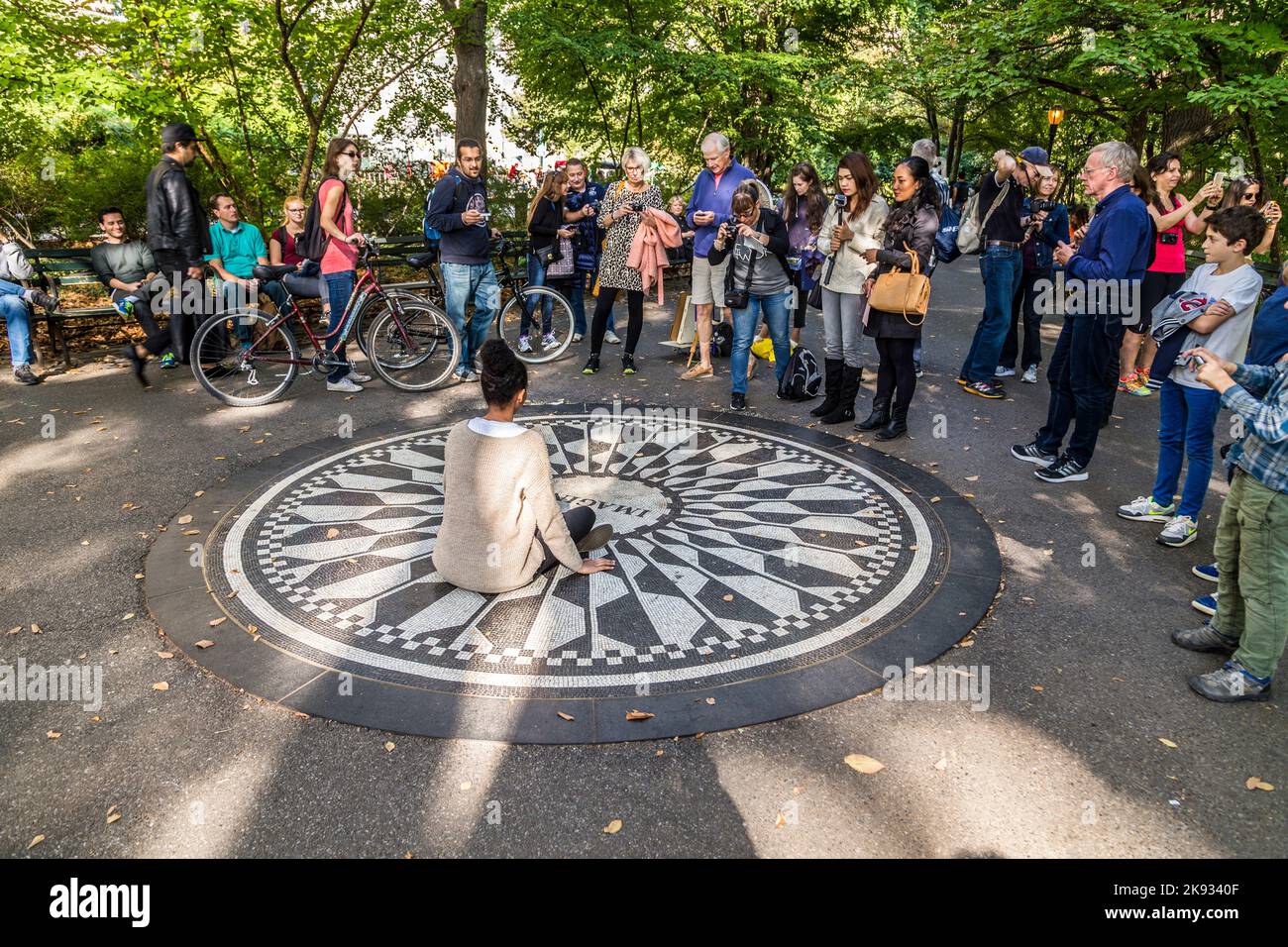 New York, USA - OCT 21, 2015: people having their picture taken on the IMAGINE mosaic in Strawberry Fields Central Park in Manhattan. People come all Stock Photo