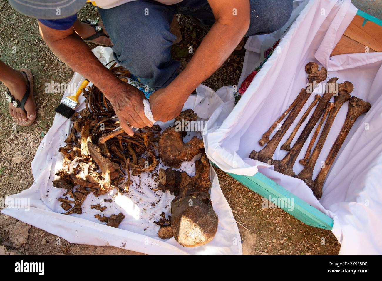 José Alfredo Yam Vargas cleans the bones and skull of his brother-in-law, who died in February 2019, at the cemetery of Pomuch, Campeche state, Mexico on October 22, 2022. Every year in preparation for Hanal Pixán, the Mayan Day of the Dead celebration, members of the Pomuch community in southeastern Mexico extract bones from their niches and carefully clean them – an ancestral tradition seen as a gesture of love and a way to get closer to deceased family members. This ritual, which in Mayan is known as Choo Ba’ak, can be done for the first time when a person has been dead for three years. Pom Stock Photo