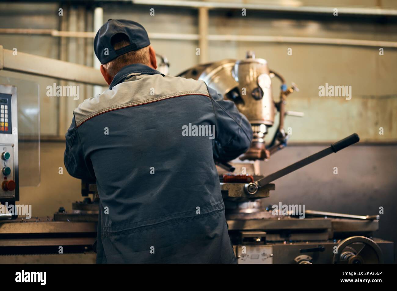 Old milling machine operator works with vintage equipment Stock Photo
