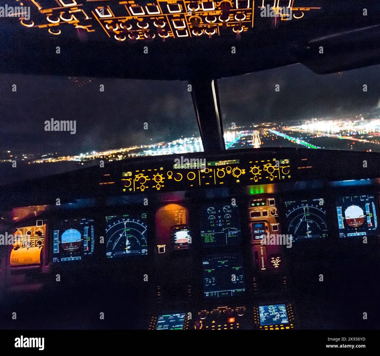 FRANKFURT, GERMANY - OCT 10, 2014: landing by night with a commercaial aircraft A320 at the airport of Frankfurt, Germany. Stock Photo