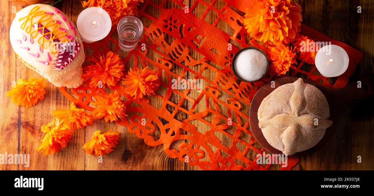 Sugar skull with Pan de Muerto and Cempasuchil flowers or Marigold and Papel Picado. Decoration traditionally used in altars for the celebration of th Stock Photo