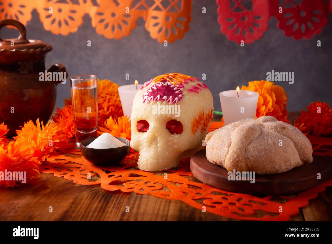Pan de Muerto with sugar skull and Cempasuchil flowers or Marigold and Papel Picado. Decoration traditionally used in altars for the celebration of th Stock Photo