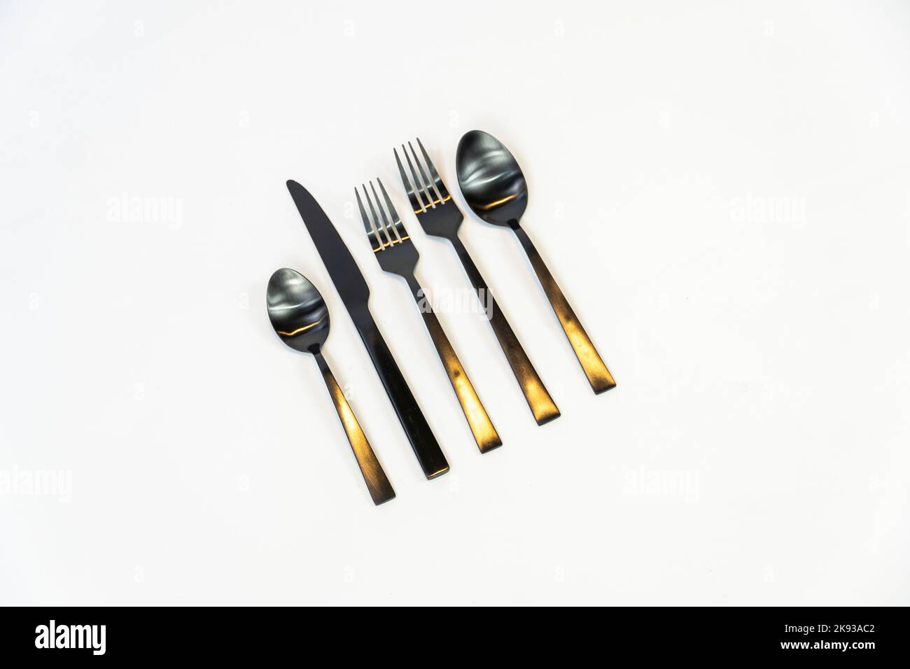 Rack of kitchen utensils, isolated on white. Stainless steel with black