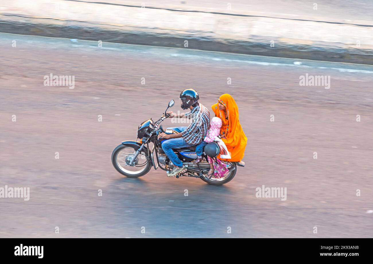 JAIPUR, INDIA - NOV 13, 2011: people on motorBike in Jaipur, India.  Jaipur, also popularly known as the Pink City, is the capital and largest city of Stock Photo
