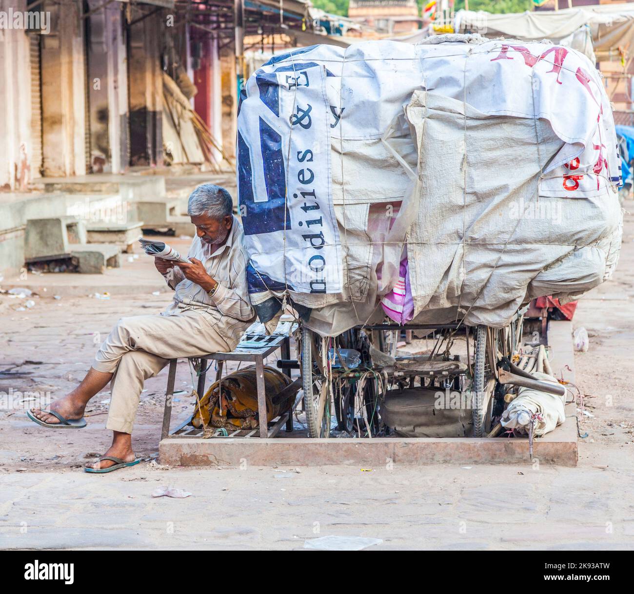 JODHPUR, INDIA - OCTOBER 23, 2012: man rests in his Cycle rickshaw  in Jaipur, India. Cycle rickshaws were introduced in the 1940's and have a fixed q Stock Photo