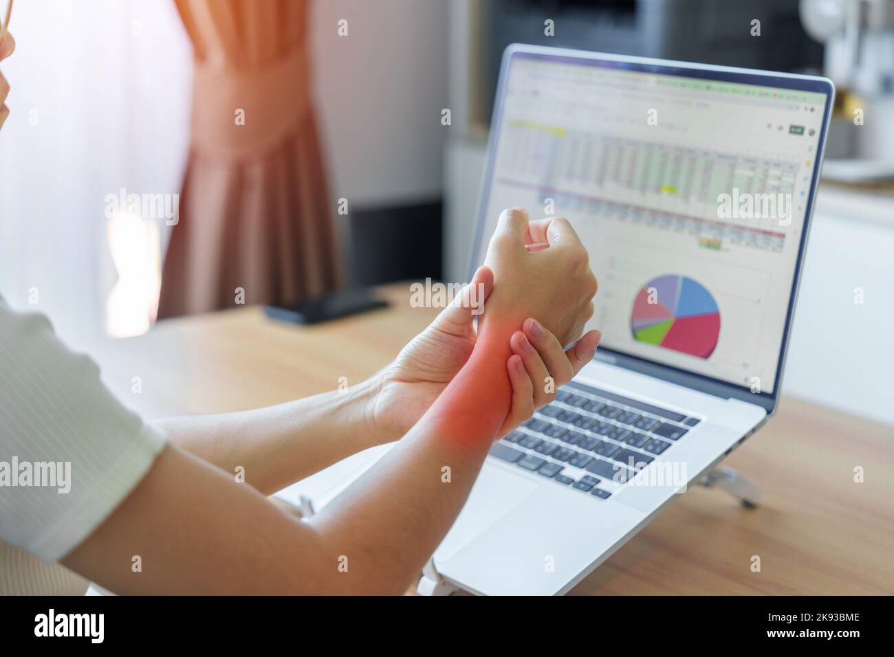 Woman having wrist pain when using laptop computer and mouse during