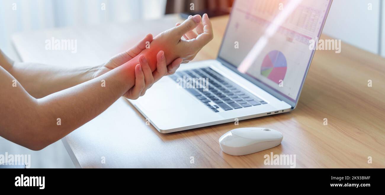 Woman having wrist pain when using mouse during working long time on