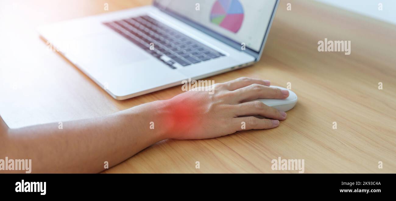 Woman having wrist pain when using mouse during working long time on
