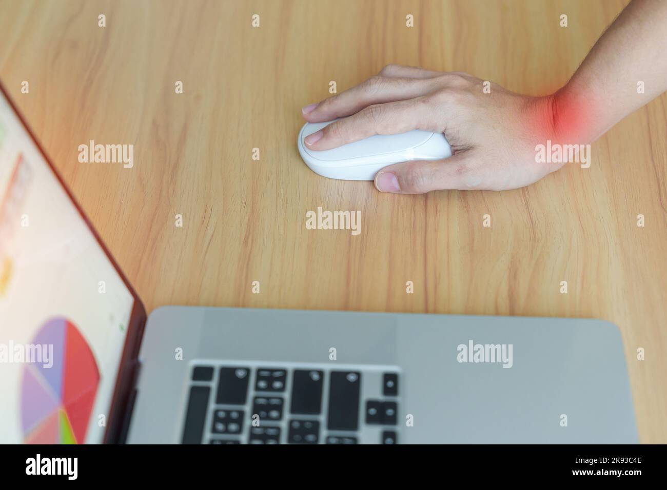 Woman having wrist pain when using mouse during working long time on