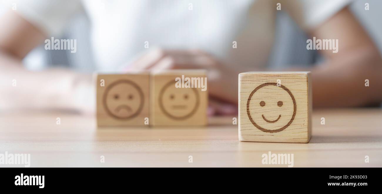 Happy smile face choosing from Emotion block for customer review, good experience, positive feedback, satisfaction, survey, evaluation, assessment, mo Stock Photo