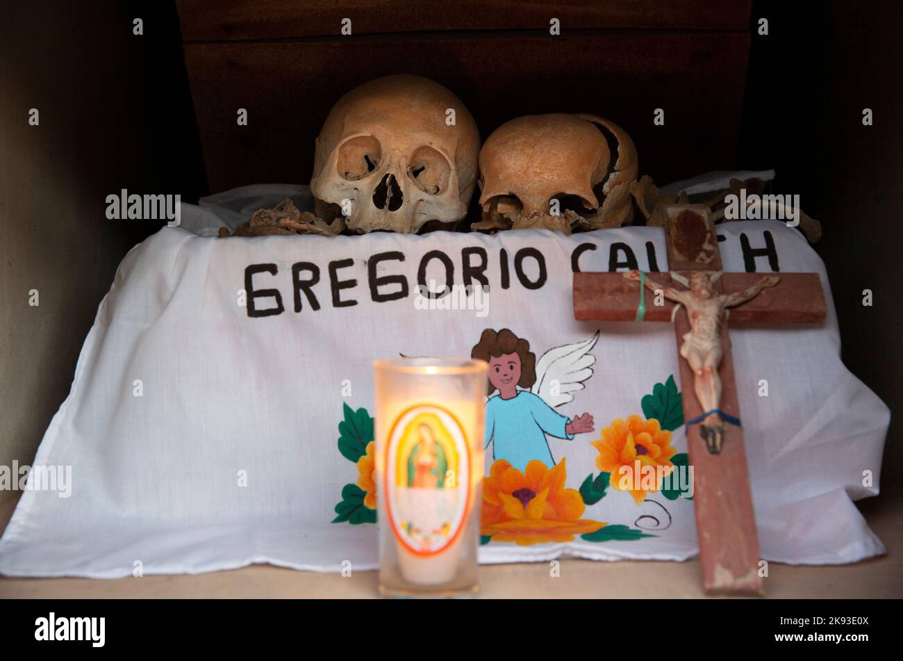 Dried-up skulls and bones are seen wrapped in embroidered white tablecloths bearing the names of the deceased, and placed in wooden crates inside a niche at the cemetery in Pomuch, Campeche state, Mexico on October 22, 2022. Every year in preparation for Hanal Pixán, the Mayan Day of the Dead celebration, members of the Pomuch community in southeastern Mexico extract bones from their niches and carefully clean them – an ancestral tradition seen as a gesture of love and a way to get closer to deceased family members. This ritual, which in Mayan is known as Choo Ba’ak, can be done for the first Stock Photo