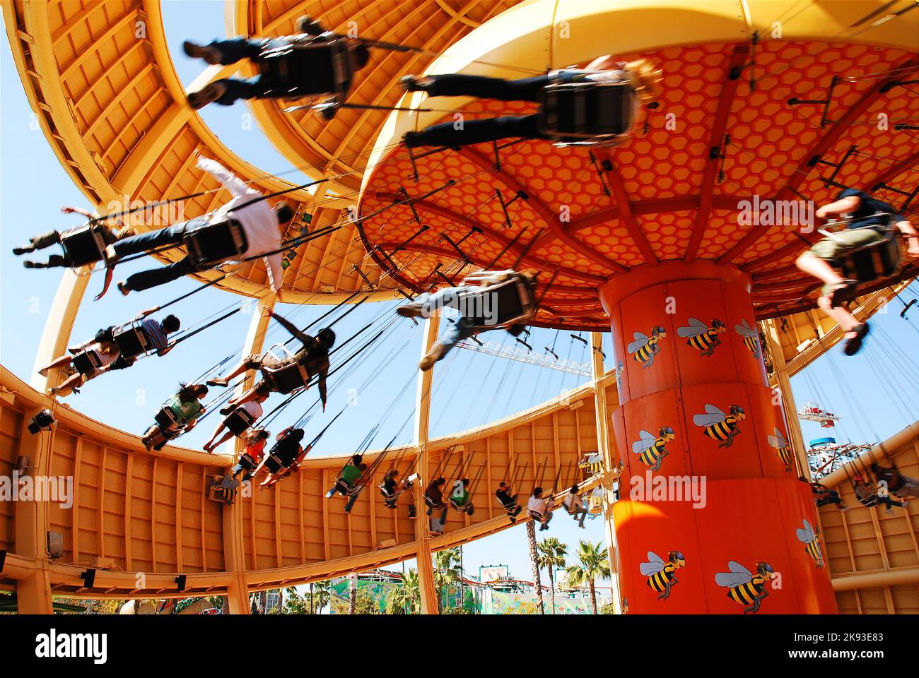 People take a ride on the fast moving Orange Stinger, a swing ride in Disney's California Adventure Stock Photo