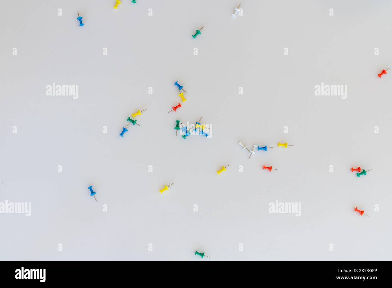 Push pins scattered on white background Stock Photo
