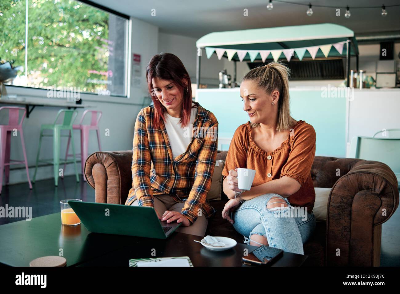 Two women friends talking sofa hi-res stock photography and images - Alamy